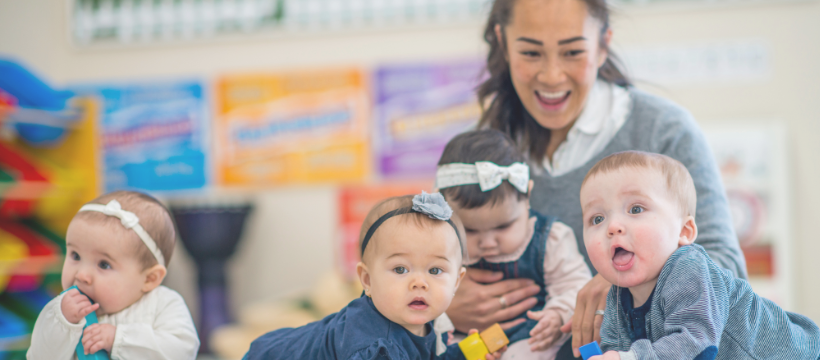 An early childhood teacher playing with young children